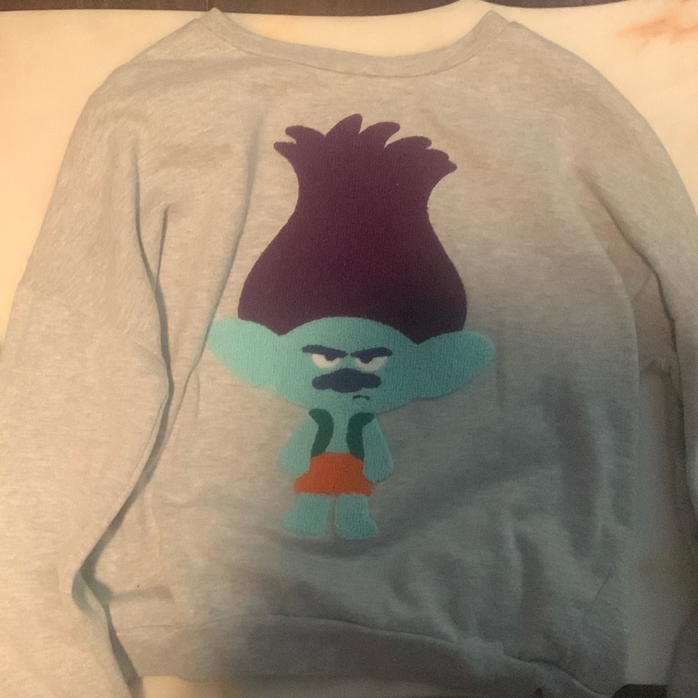 I am selling a light grey crew neck with a troll character on it!!